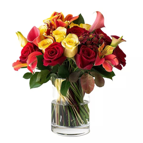 A vibrant bouquet of mixed flowers, including red and yellow roses, in a glass vase.