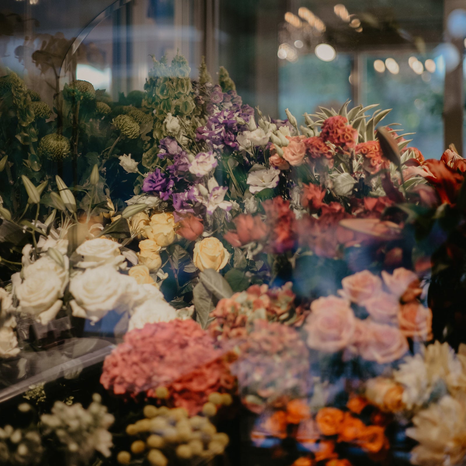 Bouquets of colorful flowers on display in window