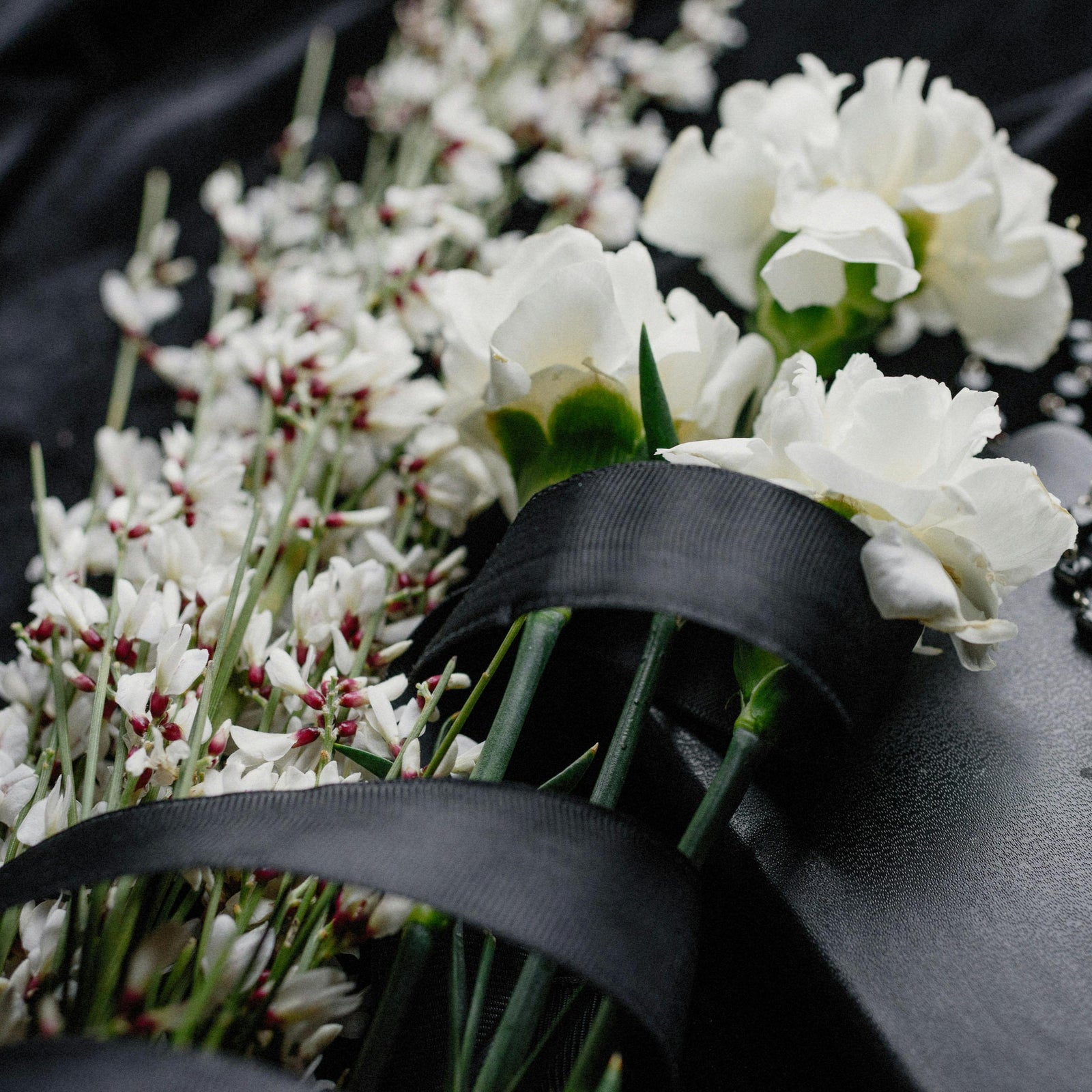 White flowers with black ribbon (pexels-kseniachernaya-8986709)