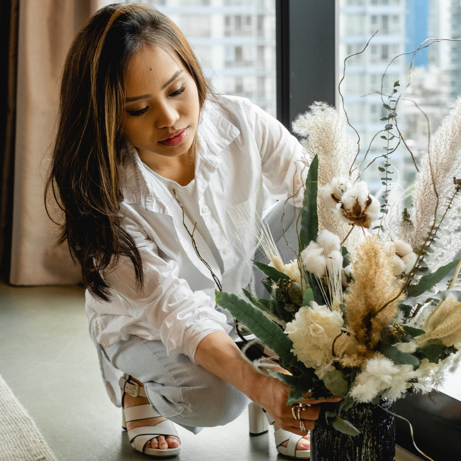 Woman arranging flowers in vase